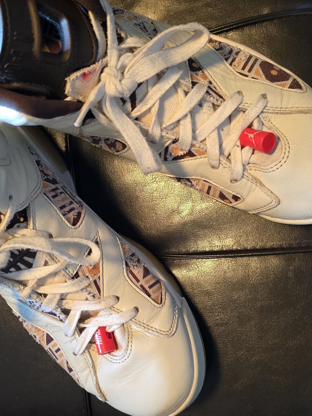 Jordan White Sneakers with Brown Pattern Accents and Red Lace Locks